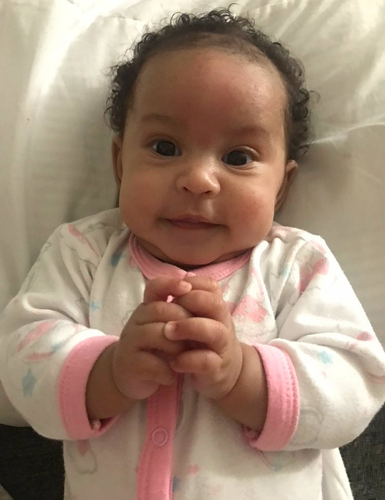 Anaya is registered to the contest to win money with this photo: baby_toddler_clothing, cheek, chin, ear, eye, eyebrow, gesture, hair, happy, head, iris, lip, mouth, nose, person, pink, product, skin, sleeve, smile