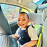 toddler, child, car_seat, smiling, happy, indoors, seatbelt, clothing, overalls, car_interior, sunlight, window, safety, young_child, portrait, person, cute, seat, car, daylight