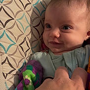 Mazilen is registered to the contest to win money with this photo: baby, infant, smile, hand, blanket, pattern, colorful, face, eyes, cute, child, clothing, bed, comfort, playful, skin, person, portrait, baby_girl, baby_boy