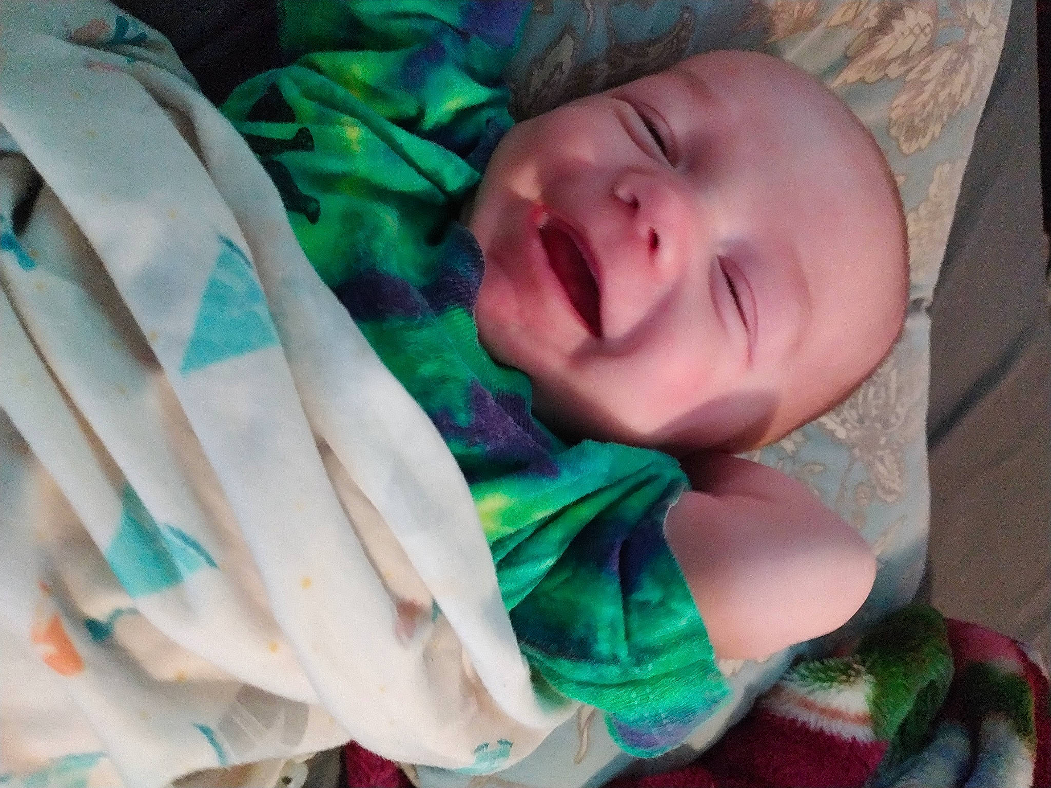 Dakota is registered to the contest to win money with this photo: arm, baby, baby_products, baby_toddler_clothing, cheek, child, comfort, finger, fun, gesture, grass, green, happy, nail, pattern, person, smile, textile, thumb, toddler