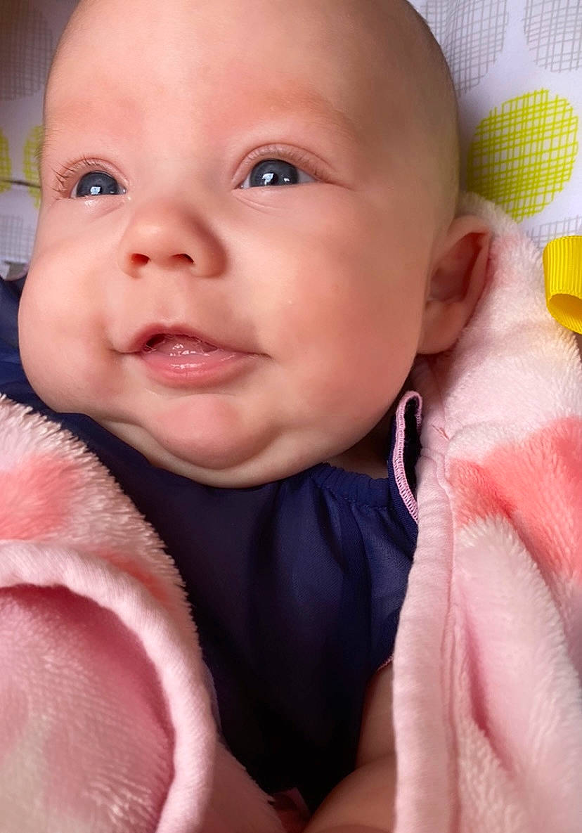 Evelyn joined the competition — help win amazing prizes! baby, baby_toddler_clothing, cheek, child, chin, comfort, eyebrow, eyelash, finger, happy, iris, linens, lip, nail, nose, person, pink, skin, smile, thumb