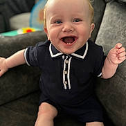 Jaxon-Joseph joined the competition — help win amazing prizes! baby, child, smiling, blue_eyes, toothy_grin, navy_outfit, short_sleeves, couch, indoor, happy, cute, infant, person, sitting, comfortable, light_skin, curly_hair, casual_clothing, portrait, joyful