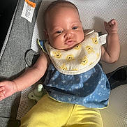 Journee is registered to the contest to win money with this photo: arm, baby, baby_seat, bib, blue_top, cozy, crochet_blanket, cute, eyes, fabric, face, hand, indoor, infant, mesh, pacifier, portrait, soft_lighting, warning_label, yellow_pants