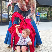 Alicia joined the competition — help win amazing prizes! adult, barefoot, building, child, costume, face_paint, fake_blood, fruit, jeans, man, outdoor, playful, red_blanket, sidewalk, stroller, toddler, tshirt, urban, window, zombie_costume