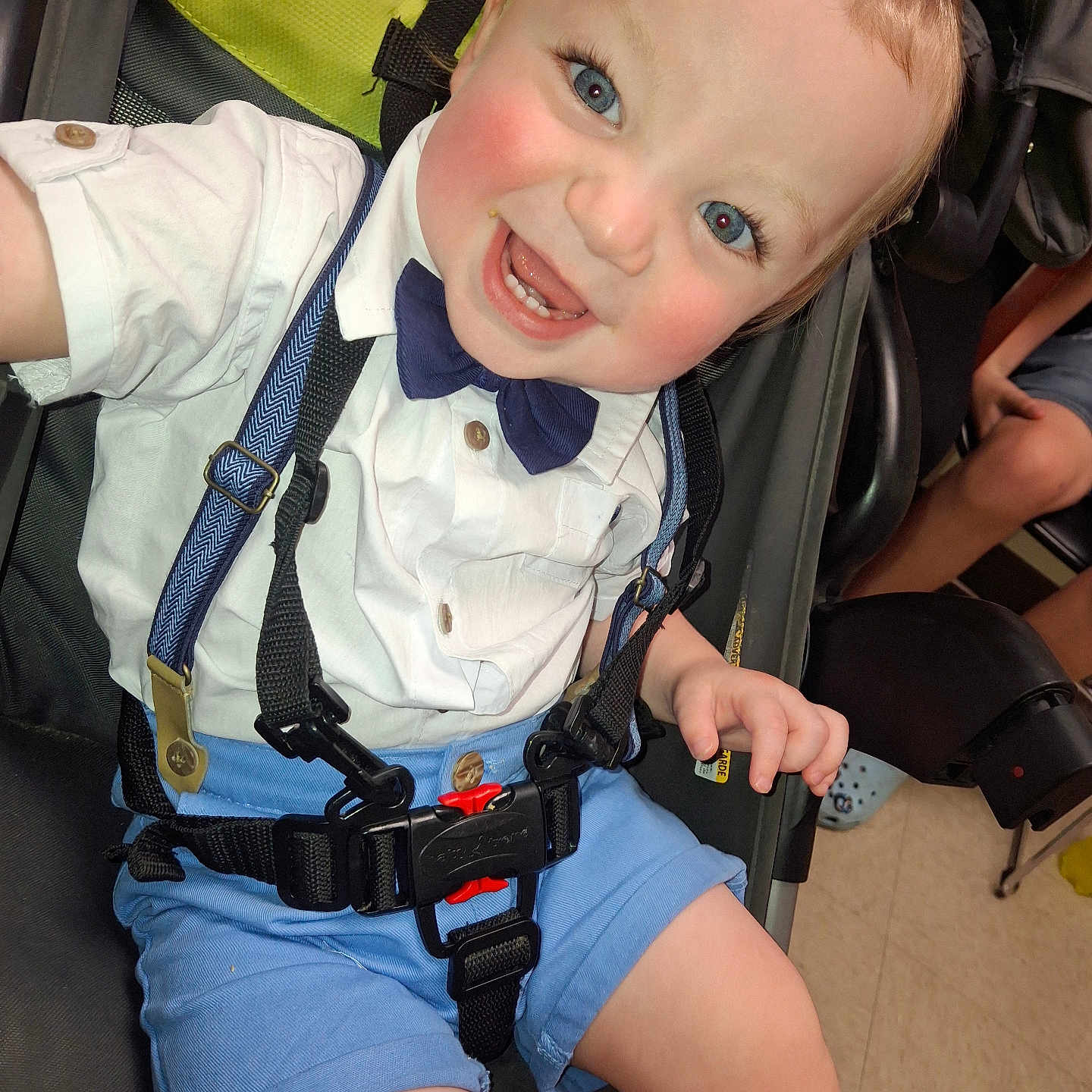 Kaleb is registered to the contest to win money with this photo: baby, blue_eyes, blue_shorts, bow_tie, child, cute, face, floor, hair, hand, happy, indoor, person, seatbelt, skin, smiling, stroller, suspenders, toddler, white_shirt