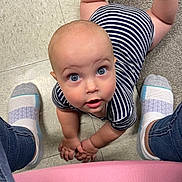 Silas joined the competition — help win amazing prizes! baby, child, striped_onesie, floor, tile_floor, carpet, socks, jeans, legs, looking_up, wide_eyes, curious, hands, crawling, indoor, person, infant, cute, portrait, casual