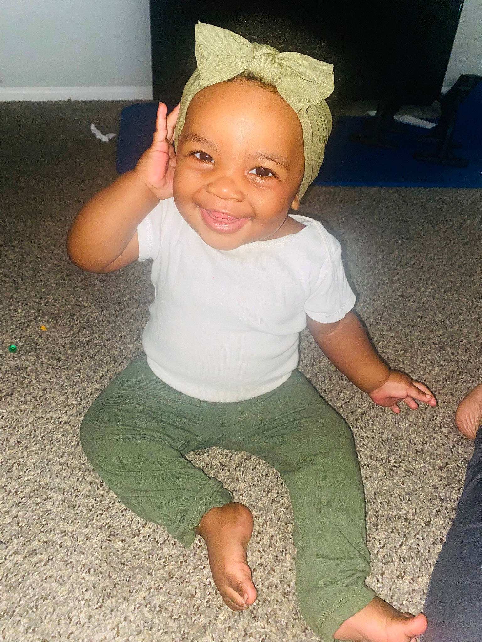 Jacelynn is registered to the contest to win money with this photo: baby_toddler_clothing, cheek, comfort, eye, face, facial_expression, finger, floor, flooring, fun, happy, joint, joy, knee, leg, person, shoulder, sleeve, smile, thigh