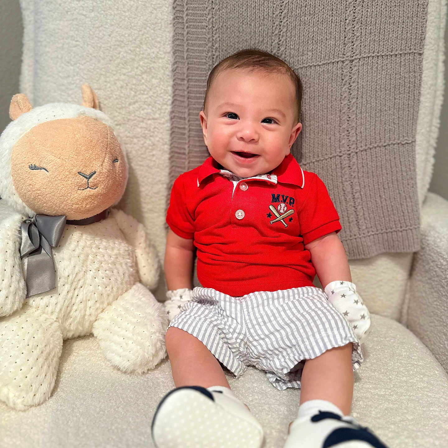 Kaleb Cole joined the competition — help win amazing prizes! apparel, baby, child, cozy_chair, cute, face, happy, home, indoor, infant, knitted_blanket, mittens, plush_toy, portrait, red_shirt, seated, smile, soft_shoes, striped_shorts, stuffed_animal