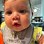baby, bib, bodypart, eating, face, food, hand, head, person, photography, portrait