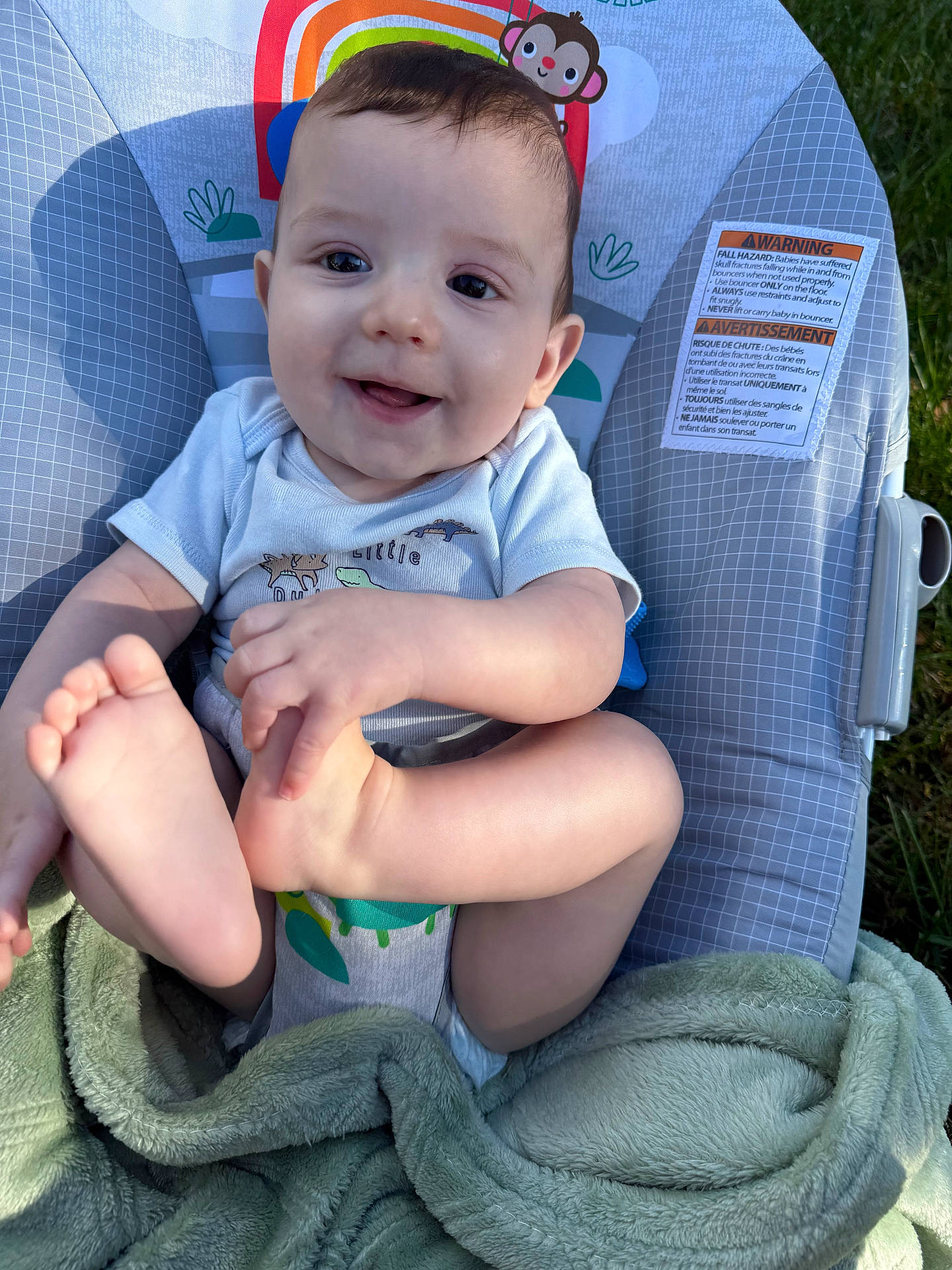 baby, baby_seat, blanket, child, clothing, comfort, cute, fabric, foot, grass, hand, happy, infant, monkey_design, outdoor, playful, portrait, seat, smiling, young
