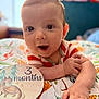 Cain is registered to the contest to win money with this photo: baby, infant, child, milestone_card, 3_months, blanket, pattern, dragon_illustration, curious_eyes, open_mouth, hands, colorful, soft_focus, cute, lying_down, close_up, portrait, indoor, happy, young
