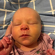 Everleigh joined the competition — help win amazing prizes! newborn, baby, infant, sleeping, face, portrait, closed_eyes, pink_outfit, floral_pattern, blanket, plaid, bed, indoors, hands, fists, peaceful, close_up, child, resting, photography