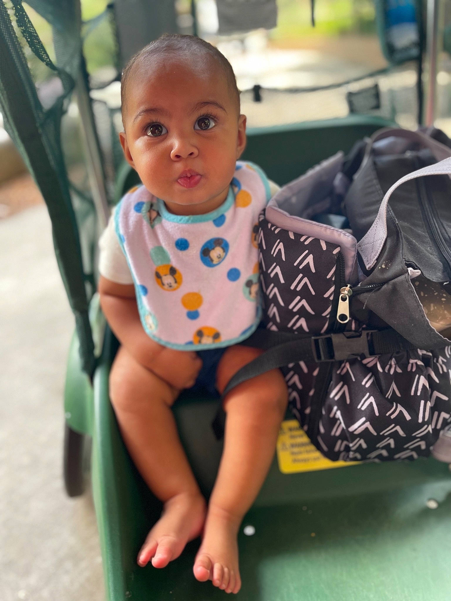 Brayden is registered to the contest to win money with this photo: baby, baby_toddler_clothing, bag, child, comfort, electric_blue, eye, fun, happy, human_leg, joint, knee, leisure, luggage_and_bags, pattern, person, product, sitting, sleeve, thigh
