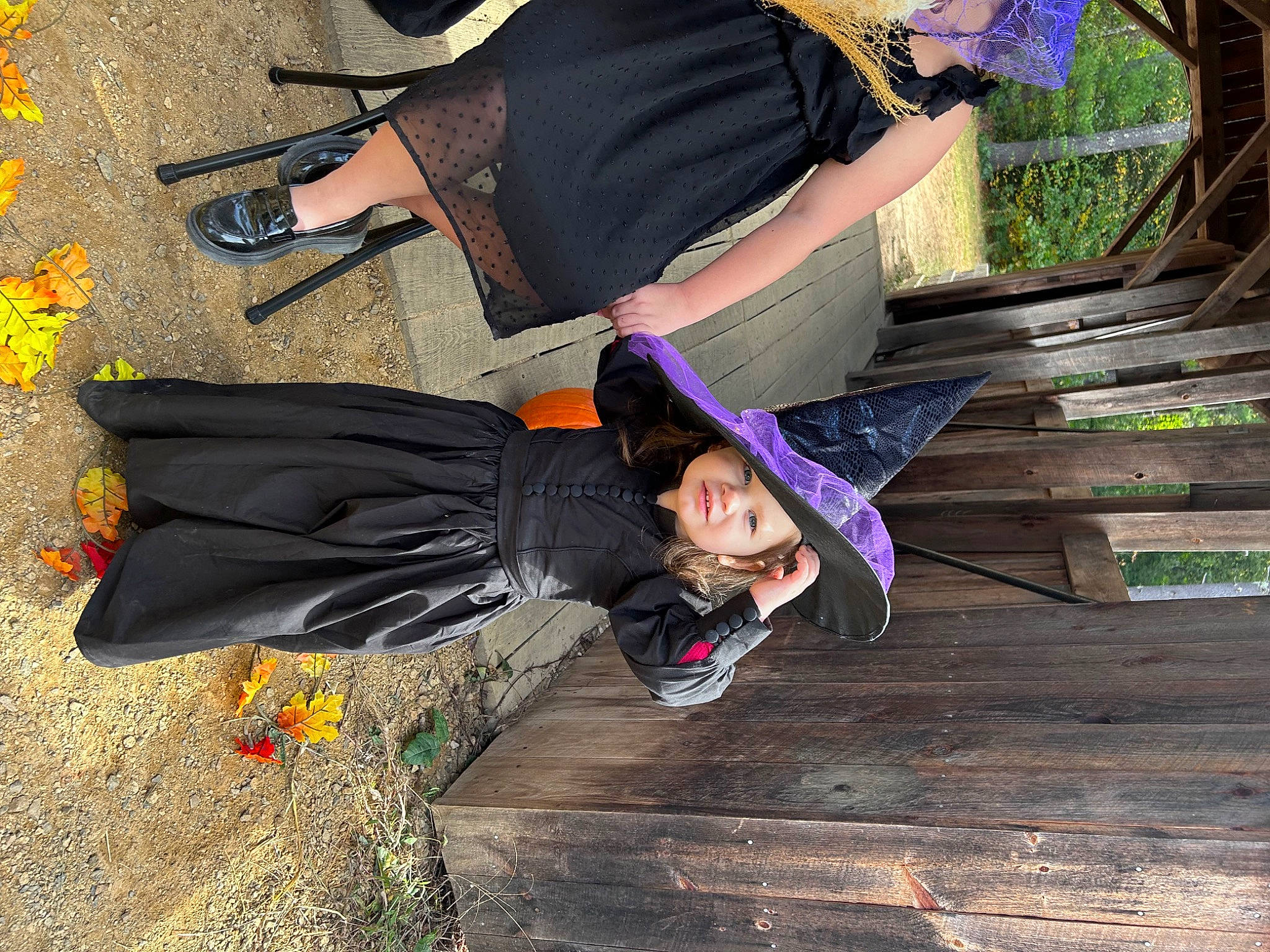 Gemma is registered to the contest to win money with this photo: black, boot, fun, grass, hardwood, headwear, human_leg, leg, leisure, person, plant, purple, recreation, road_surface, shoe, sidewalk, sitting, sneakers, thigh, tree