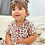 toddler, child, pajamas, leopard_print, pink, hair_ribbons, smiling, indoor, bed, blanket, cute, happy, person, portrait, young_child, clothing, sitting, face, skin, eyelashes