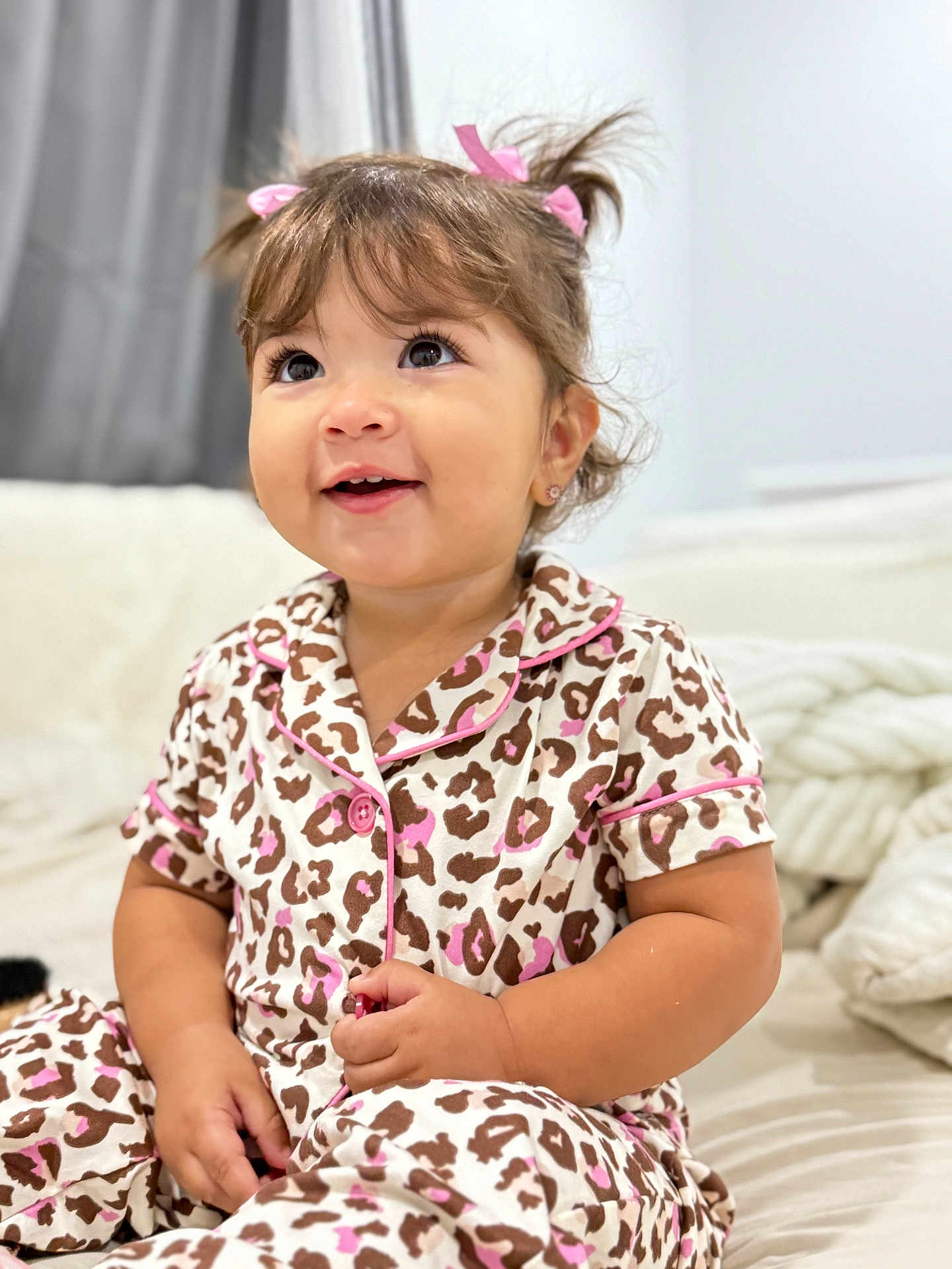 Diana joined the competition — help win amazing prizes! toddler, child, pajamas, leopard_print, pink, hair_ribbons, smiling, indoor, bed, blanket, cute, happy, person, portrait, young_child, clothing, sitting, face, skin, eyelashes