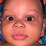 Myles is registered to the contest to win money with this photo: baby, baby_face, child, close_up, colorful_blanket, curious_expression, cute, face, head, human, indoors, infant, looking_up, patterned_background, person, portrait, skin, soft_skin, wide_eyes, young_child