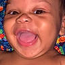 Myles is registered to the contest to win money with this photo: baby, cheerful, child, closeup, colorful_background, expression, eyes, face, happy, head, infant, laughing, mouth, person, playful, portrait, skin, smiling, tongue, young
