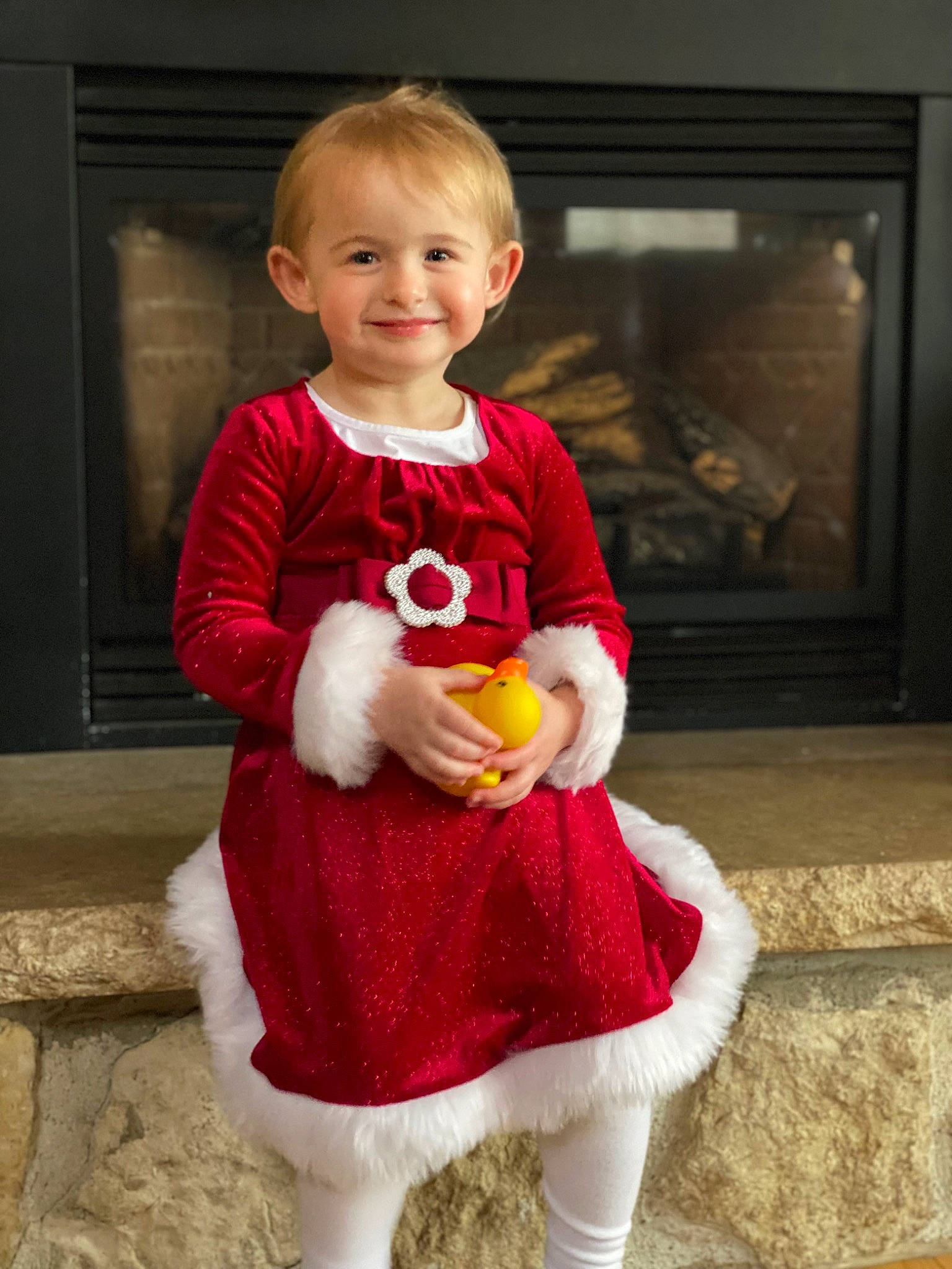 Layla is registered to the contest to win money with this photo: arm, baby, baby_toddler_clothing, child, dress, event, face, flooring, fun, hair, happy, head, human_body, human_leg, joy, knee, person, sitting, sleeve, smile