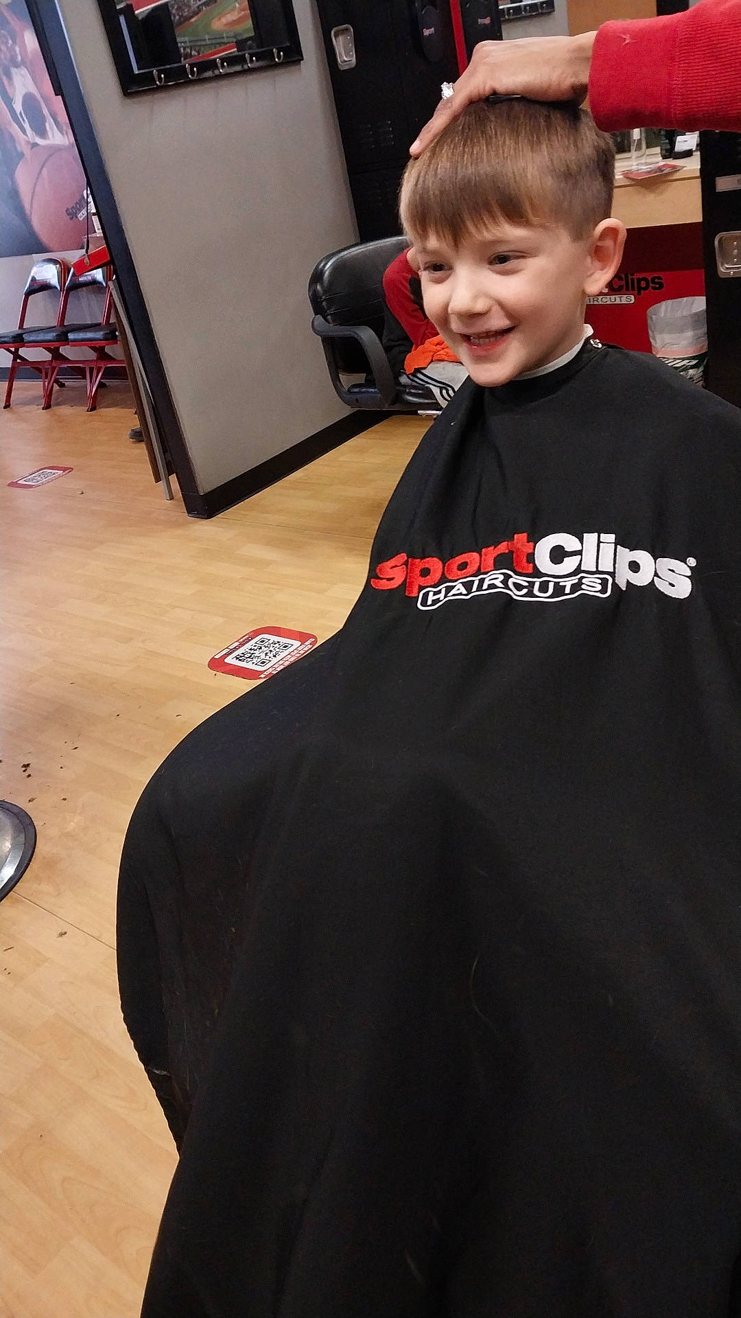 Kyson is registered to the contest to win money with this photo: carmine, carpet, chair, child, event, fashion_design, flooring, formal_wear, fun, hairstyle, joint, joy, person, room, sitting, sleeve, smile, sportswear, standing, t_shirt