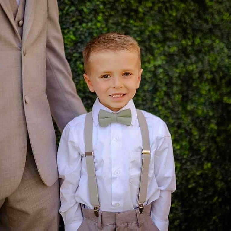 Connor is registered to the contest to win money with this photo: accessories, blazer, bowtie, boy, child, clothing, coat, dressshirt, face, formalwear, hair, head, jacket, male, person, shirt, suit, suspenders, tie, waiter