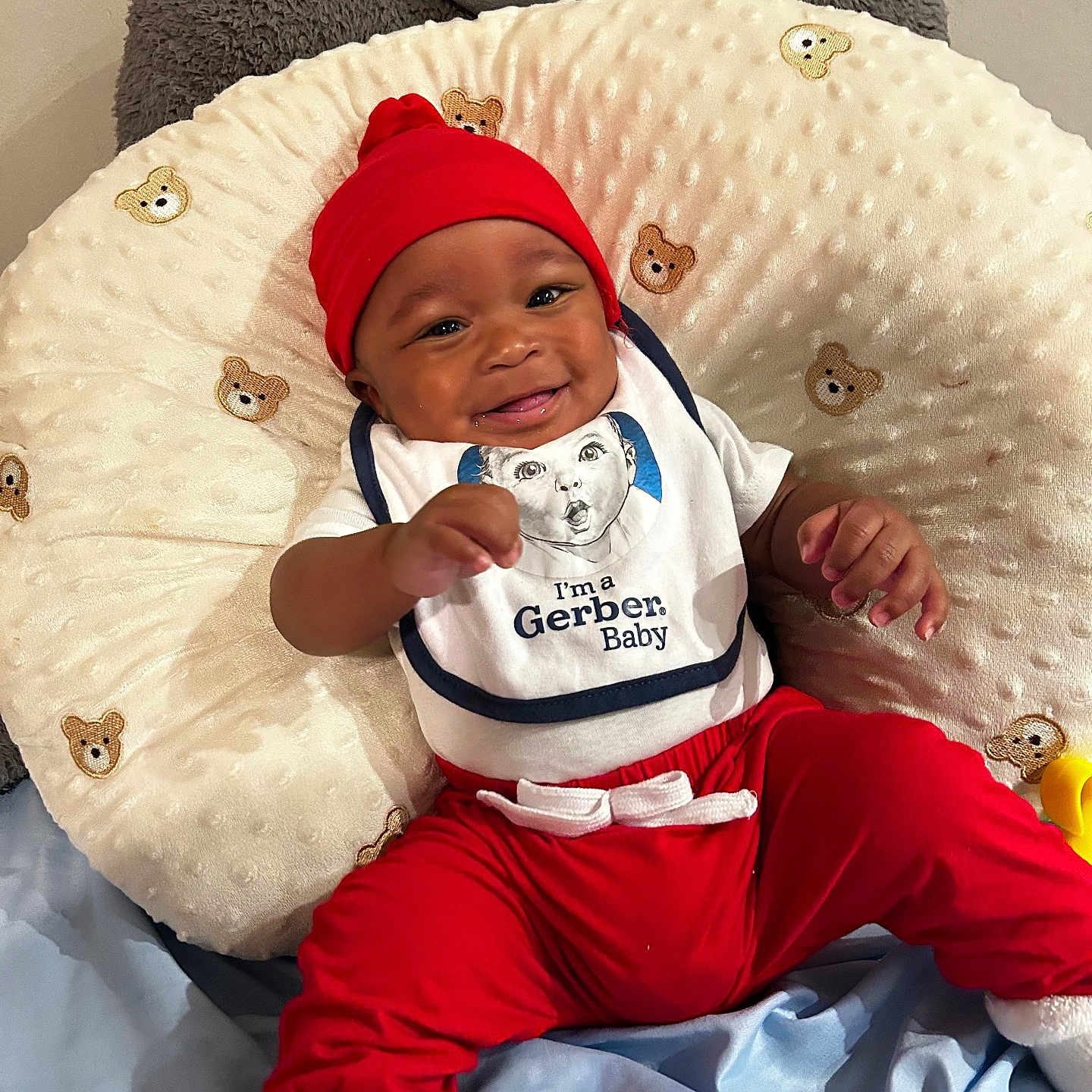 Ephraim joined the competition — help win amazing prizes! baby, babylaughing, beanbag, blanket, cap, clothing, cushion, face, furniture, happy, hat, head, homedecor, infantbed, pants, person, photography, portrait, sitting, smile