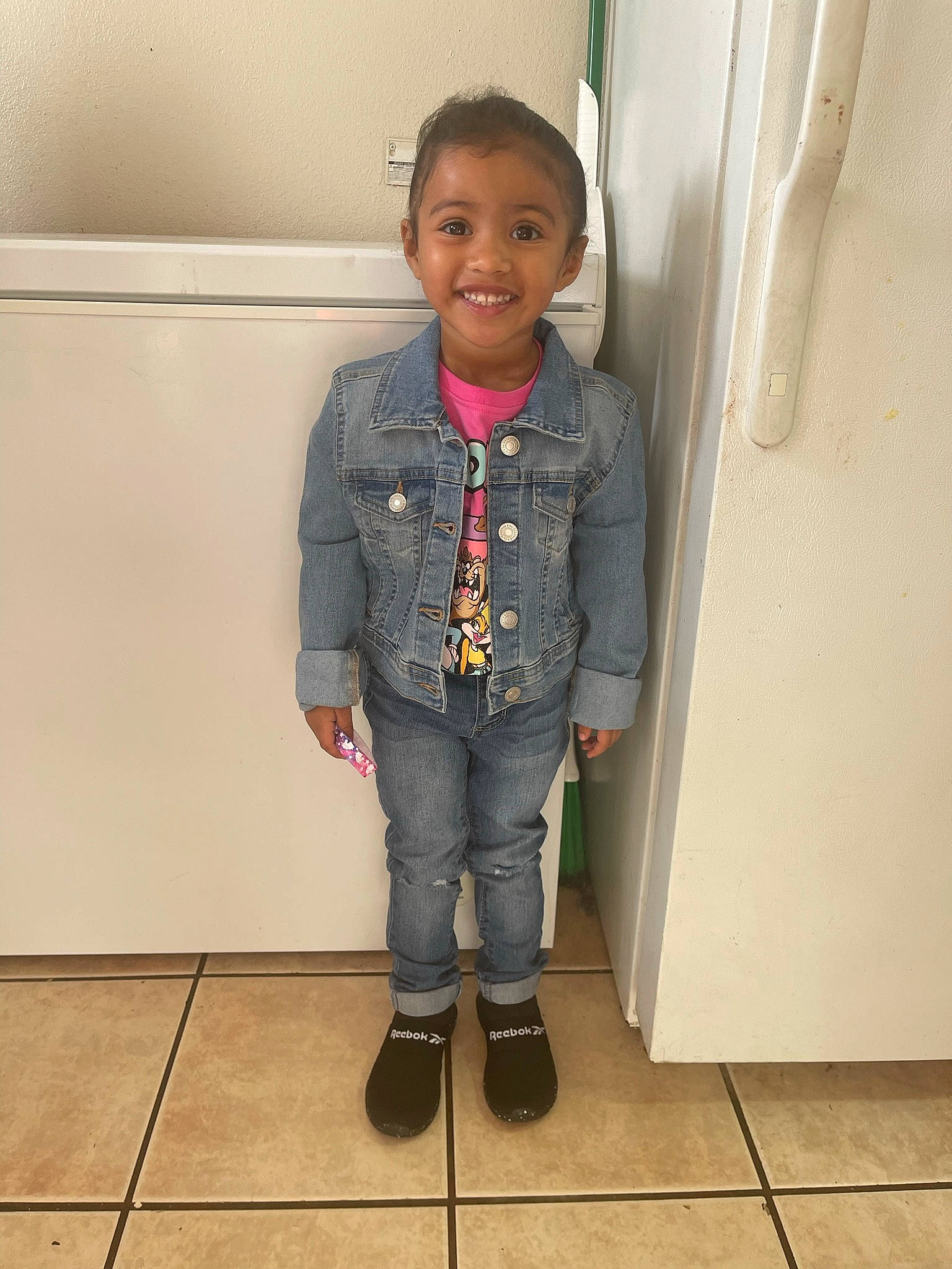 Haley is registered to the contest to win money with this photo: blazer, child, collar, denim, door, dress_shirt, fashion_design, flooring, hair, jeans, joy, pattern, person, room, sleeve, smile, toddler, uniform, waist