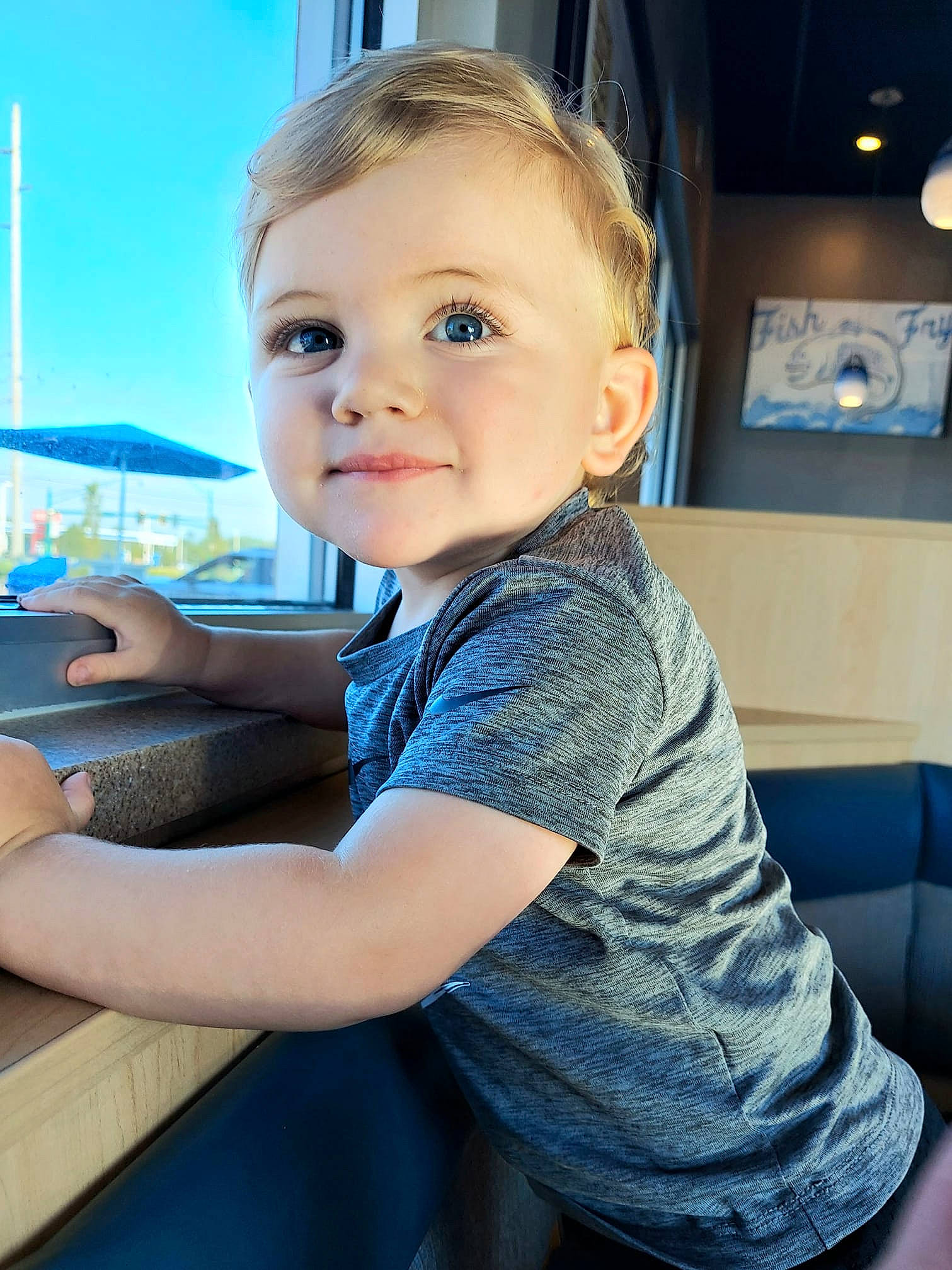 Krue is registered to the contest to win money with this photo: baby, blue, child, electric_blue, finger, fun, hand, happy, lap, leisure, person, picture_frame, recreation, shoulder, sitting, skin, sky, sleeve, smile, t_shirt