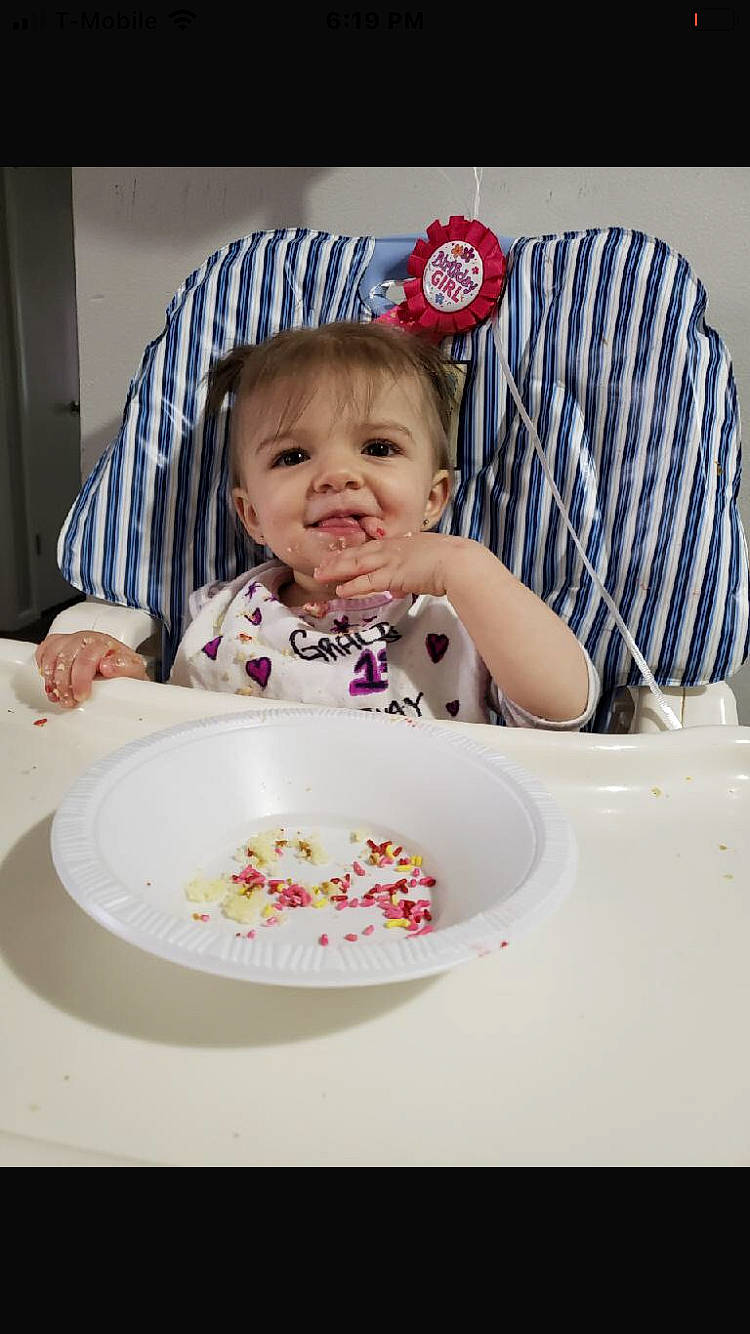 Gracie Lynn joined the competition — help win amazing prizes! baby, baby_toddler_clothing, chair, cheek, child, dishware, facial_expression, food, fun, happy, person, plate, serveware, skin, sleeve, smile, sweetness, t_shirt, table, tableware