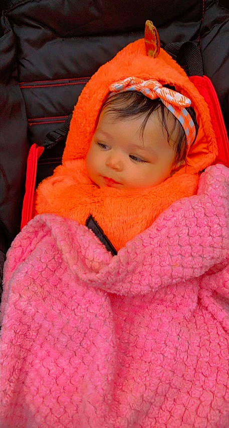 Khalani joined the competition — help win amazing prizes! baby, baby_products, baby_toddler_clothing, carmine, cheek, child, comfort, eyebrow, face, iris, linens, lip, magenta, orange, person, pink, sitting, smile, toddler, winter