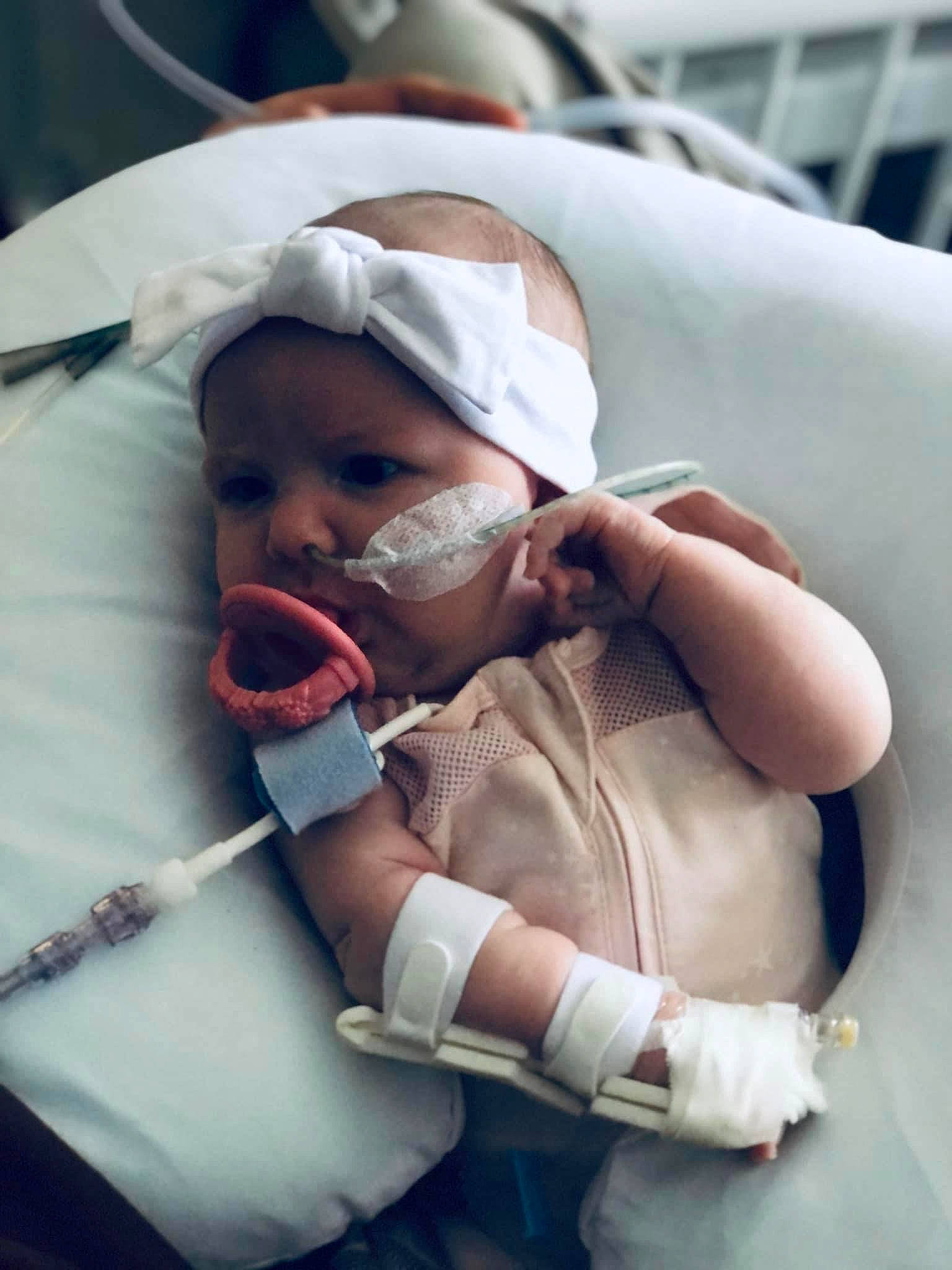 Sadie joined the competition — help win amazing prizes! baby, baby_carriage, baby_products, baby_safety, baby_toddler_clothing, child, comfort, event, eyelash, face, headwear, health_care, hospital, human_body, medical, medical_equipment, mouth, person, product, service