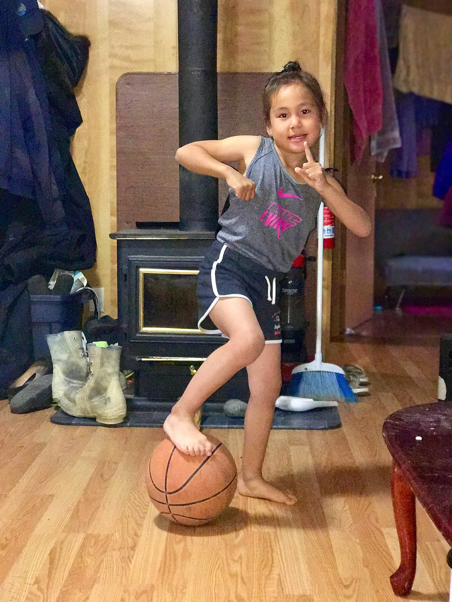 Rosa is registered to the contest to win money with this photo: balance, ball, basketball, entertainment, event, flooring, fun, happy, hardwood, human_leg, joint, joy, knee, leg, leisure, performing_arts, person, shorts, sports_equipment, sportswear