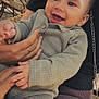 Julian participe au concours pour gagner de l'argent avec cette photo : baby, child, smiling, person, holding, hand, knitwear, gray_clothing, outdoor, cafe, chair, table, tree, daylight, happy, face, portrait, casual, seated, closeup