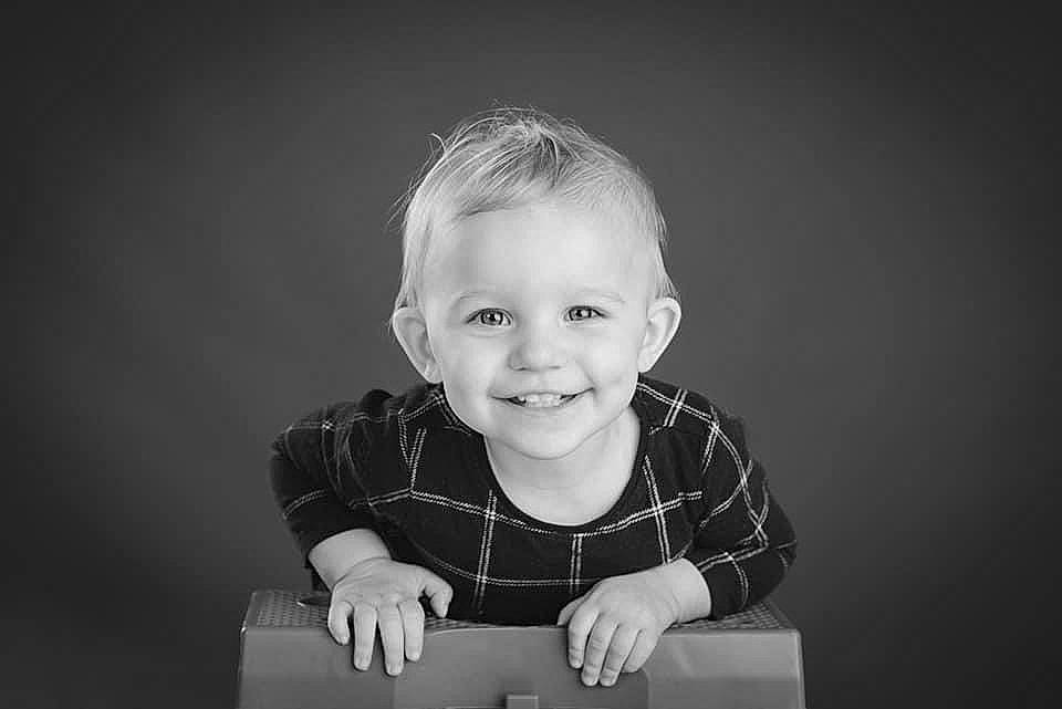 Zelda is registered to the contest to win money with this photo: arm, baby, baby_toddler_clothing, black, blond, cheek, dress, flash_photography, fun, happy, human_body, joy, laugh, monochrome, monochrome_photography, person, shirt, sitting, sleeve, smile