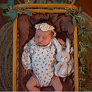 Noélie participe au concours pour gagner de l'argent avec cette photo : baby, basket, blanket, bunny, cozy, cute, floral_onesie, greenery, headband, indoor, infant, newborn, peaceful, plush_toy, portrait, resting, sleeping, soft_toy, wooden_floor, woven_rug