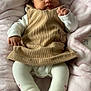 baby, corduroy, dress, white_tights, blanket, pink, infant, cute, lying_down, indoors, soft_texture, cozy, child, portrait, fist, clothing, person, young, warm, sleepwear