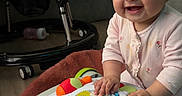 Bellamy joined the competition — help win amazing prizes! baby, child, toy, activity_center, smiling, indoor, couch, blanket, floor, baby_gear, happy, person, infant, play, colorful, furniture, clothing, head, hands, living_room