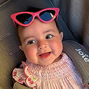 Bellamy joined the competition — help win amazing prizes! baby, child, smiling, pink_sunglasses, car_seat, seatbelt, pink_clothing, cherry_embroidery, cute, happy, portrait, infant, headwear, face, eyewear, sunlight, indoors, closeup, person, baby_girl