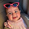 baby, child, smiling, pink_sunglasses, car_seat, seatbelt, pink_clothing, cherry_embroidery, cute, happy, portrait, infant, headwear, face, eyewear, sunlight, indoors, closeup, person, baby_girl