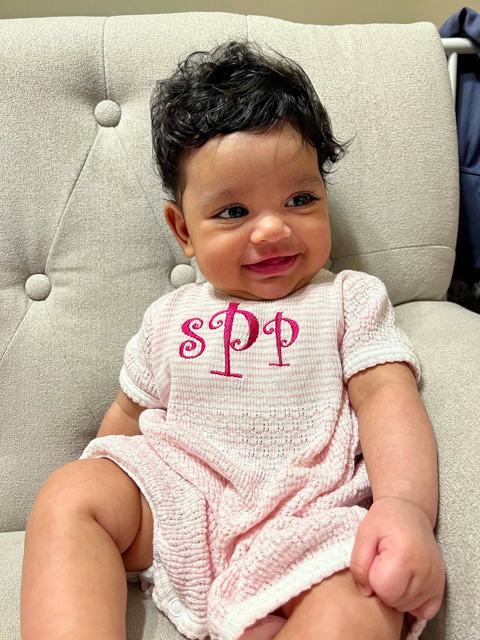 Shanti is registered to the contest to win money with this photo: arm, baby, baby_toddler_clothing, cheek, child, comfort, eye, eyelash, happy, human_body, human_leg, lip, nose, person, skin, sleeve, smile, textile, thigh, toddler