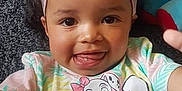Amiyah-Jane is registered to the contest to win money with this photo: baby, carpet, child, colorful, curly_hair, cute, dalmatian, happy, headband, indoors, lying_down, person, pillow, pink, playful, smiling, toddler, tongue_out, toy, tshirt