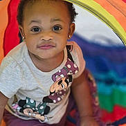 Aires joined the competition — help win amazing prizes! baby, brown_skin, child, close_up, clothing, colorful, curly_hair, earrings, eyes, face, indoors, looking_at_camera, minnie_mouse, play_area, play_tent, portrait, rainbow_colors, sitting, t_shirt, toddler
