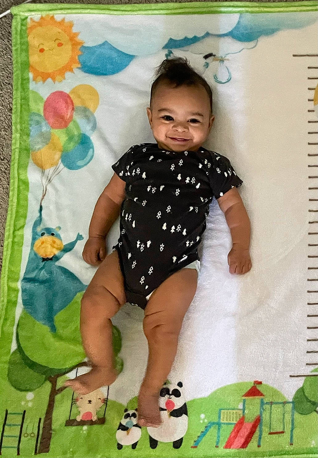 Lex is registered to the contest to win money with this photo: baby_toddler_clothing, barefoot, child, foot, fun, green, happy, human_leg, joy, knee, leisure, linens, pattern, people_in_nature, person, product, recreation, sleeve, smile, textile