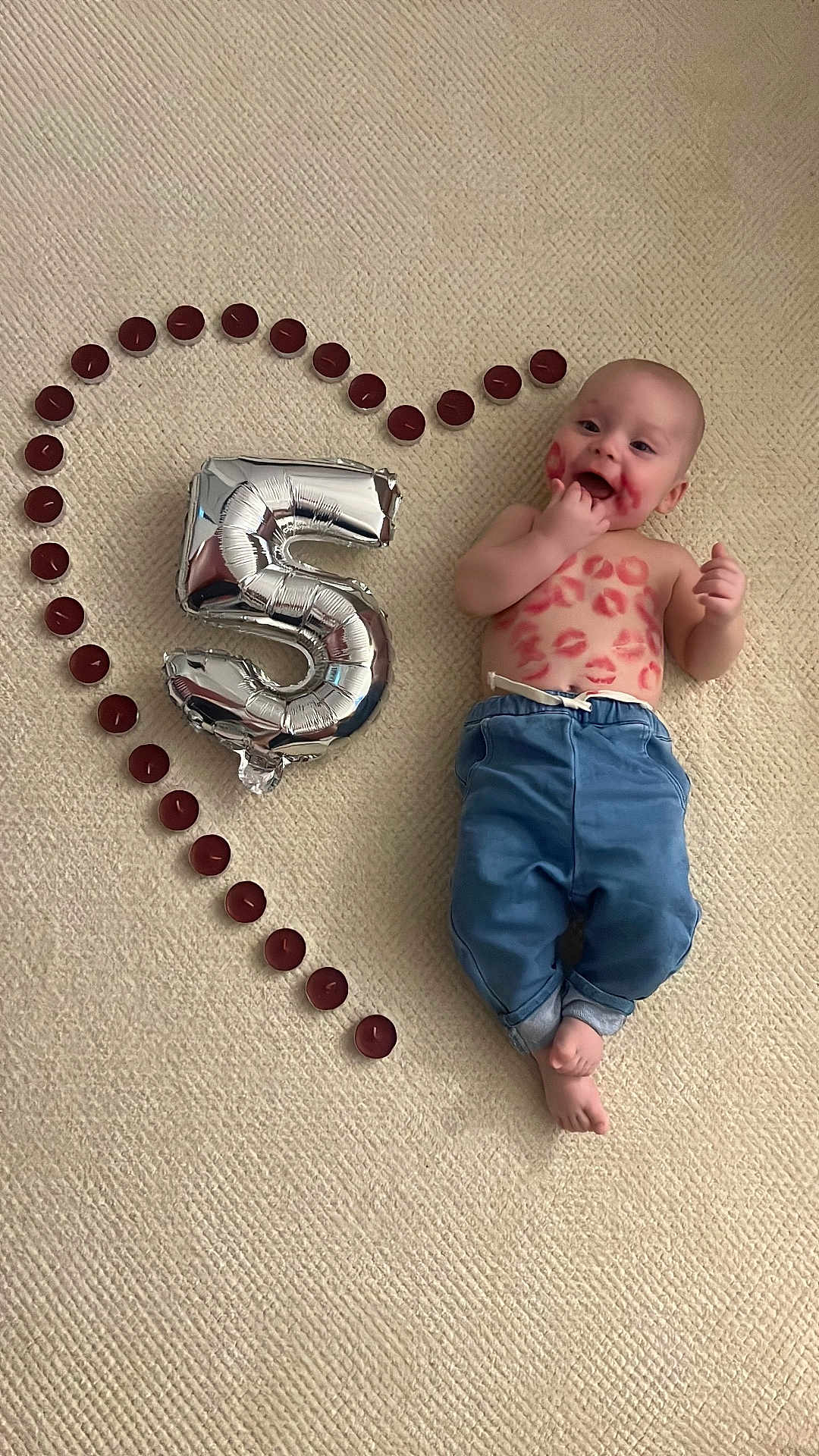 Adam-Julien participe au concours pour gagner de l'argent avec cette photo : baby, infant, balloon, number_5, kiss_marks, lipstick, metallic_balloon, heart_shape, tealight_candles, carpet, blue_pants, shirtless, smiling, lying_down, celebration, milestone, skin, feet, portrait, cozy