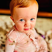 Sadie joined the competition — help win amazing prizes! child, toddler, baby, face, blue_eyes, red_hair, floral_clothing, pink_outfit, blanket, soft_texture, indoors, portrait, curious_expression, cute, sitting, close_up, person, young_child, innocent, bright_eyes