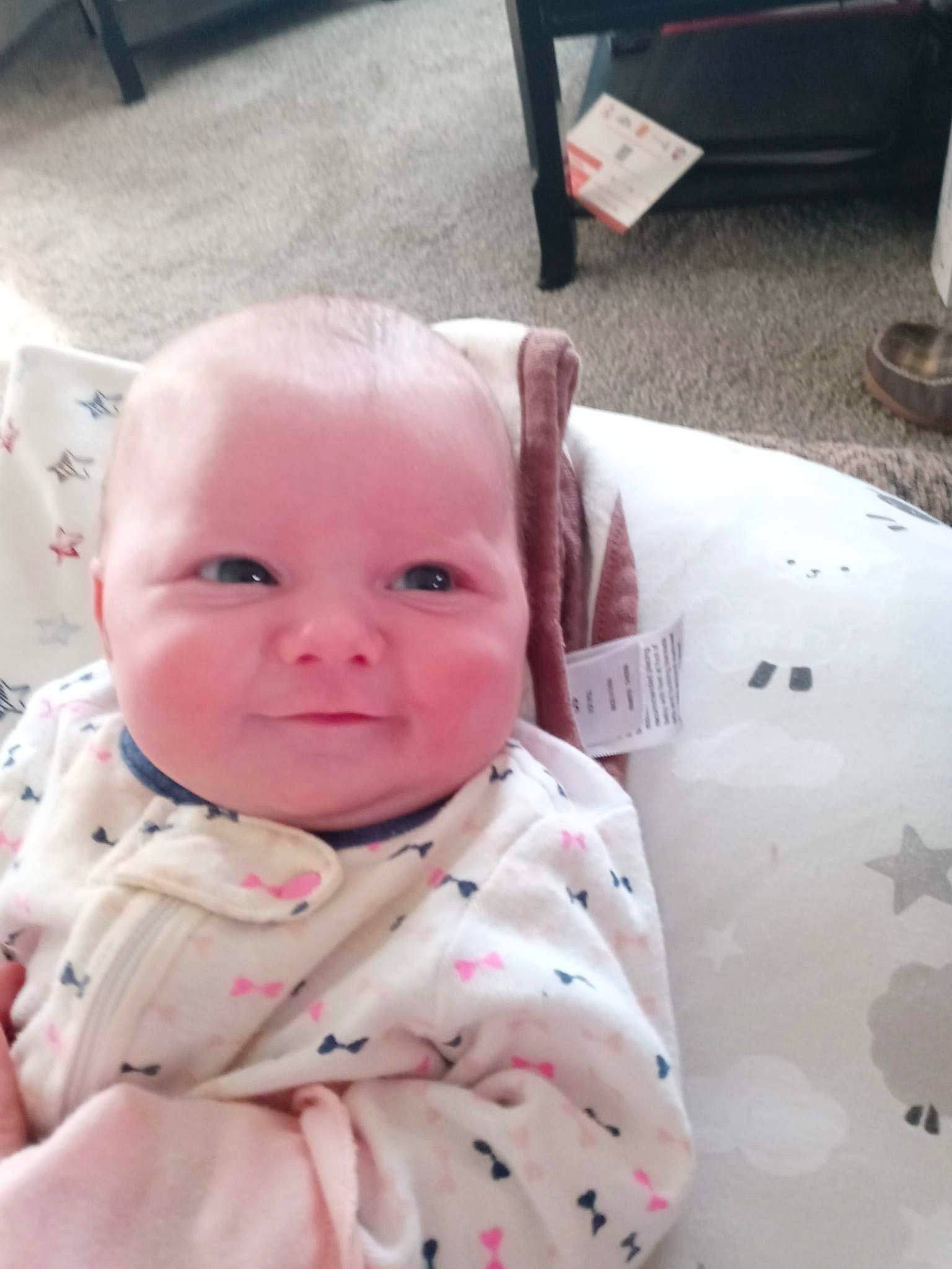 Serenity is registered to the contest to win money with this photo: baby, baby_toddler_clothing, carmine, cheek, child, comfort, fun, happy, head, linens, lip, mouth, nose, pattern, person, pink, sitting, skin, sleeve, smile