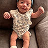 Alaynna joined the competition — help win amazing prizes! baby, bow, child, couch, cozy, floral_outfit, furniture, hands, headband, home, indoors, infant, legs, photography, portrait, raised_arms, sitting, smiling, socks, sofa