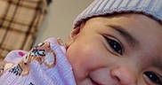 Kailani is registered to the contest to win money with this photo: baby, smile, hat, knit_hat, pom_pom, teddy_bear, purple_clothing, child, face, cute, infant, happy, closeup, indoor, portrait, warm_clothing, soft_texture, adorable, person, baby_girl