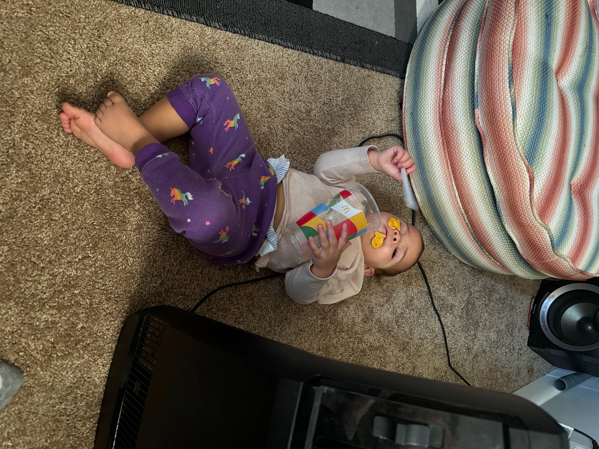 Queen is registered to the contest to win money with this photo: audio_equipment, camera, camera_lens, child, finger, flooring, foot, fruit, fun, gadget, hat, human_leg, person, play, product, room, sandal, single_lens_reflex_camera, sitting, toddler