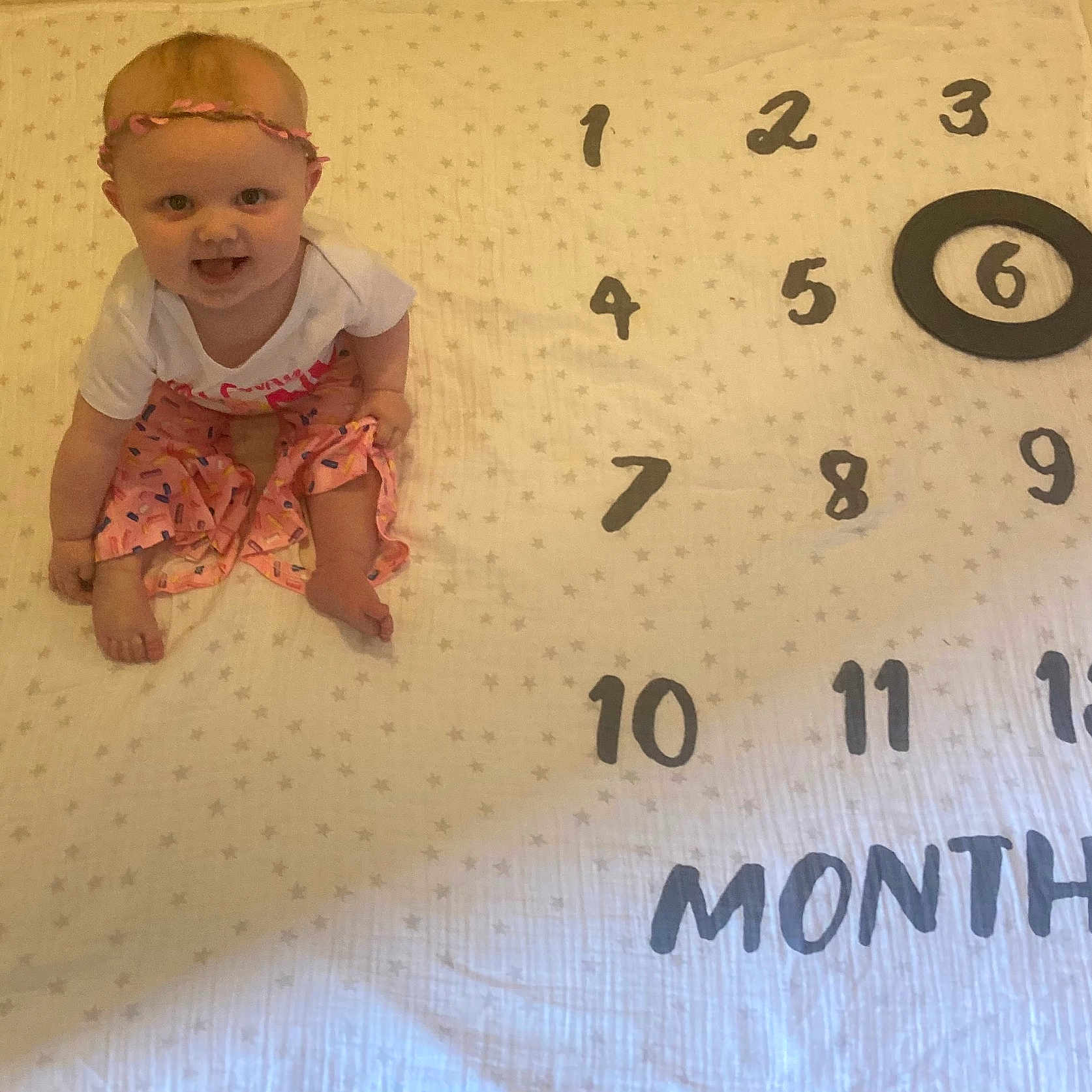 Brooklyn joined the competition — help win amazing prizes! accessories, baby, bed, bedroom, blanket, clothing, crawling, face, furniture, head, indoors, number, pants, person, photography, portrait, sitting, symbol, t_shirt, text